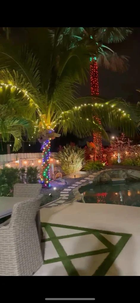 Modern home with blue roofline holiday lighting