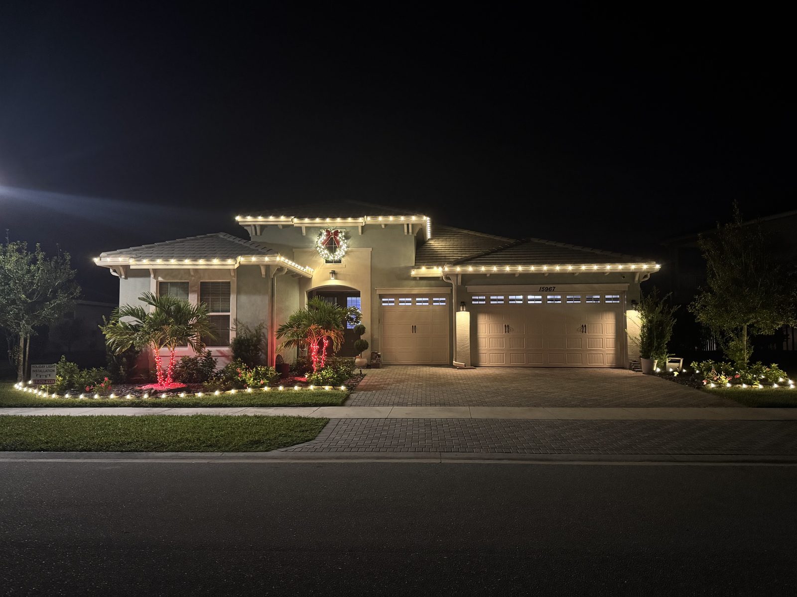 Covered entrance with lit gift boxes and candy canes