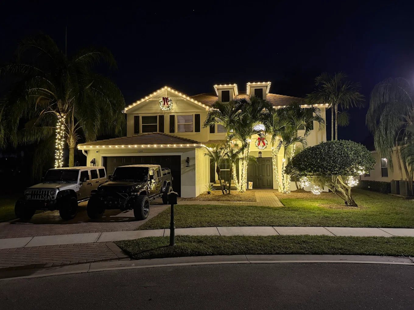 Front entrance with garland, wreaths and red bows