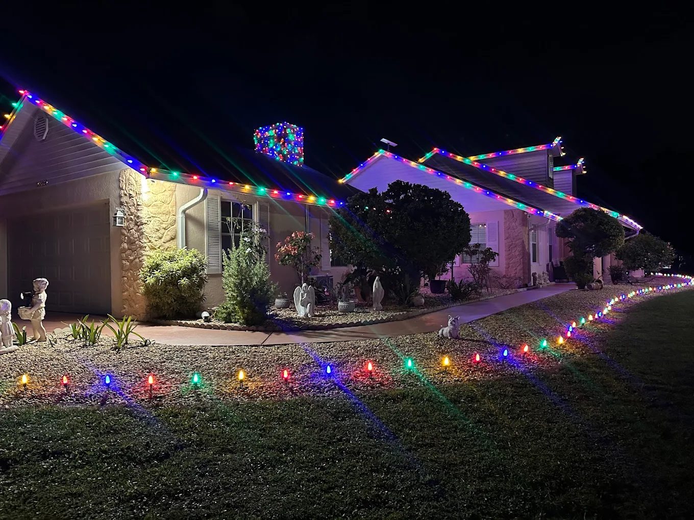 Home with multicolor roofline holiday lights
