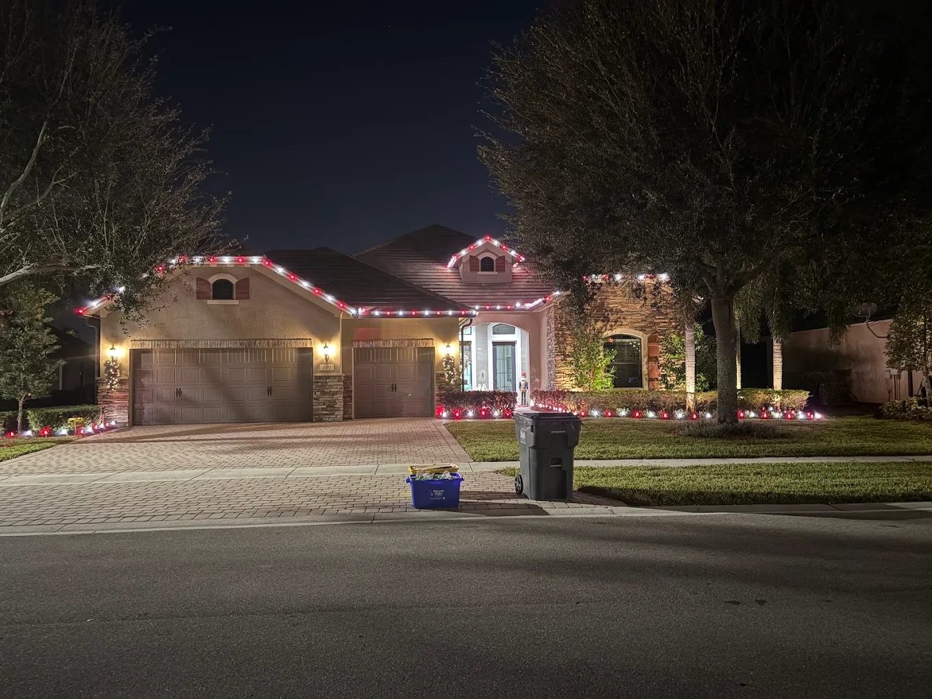 Home with crisp red and white roofline holiday lights