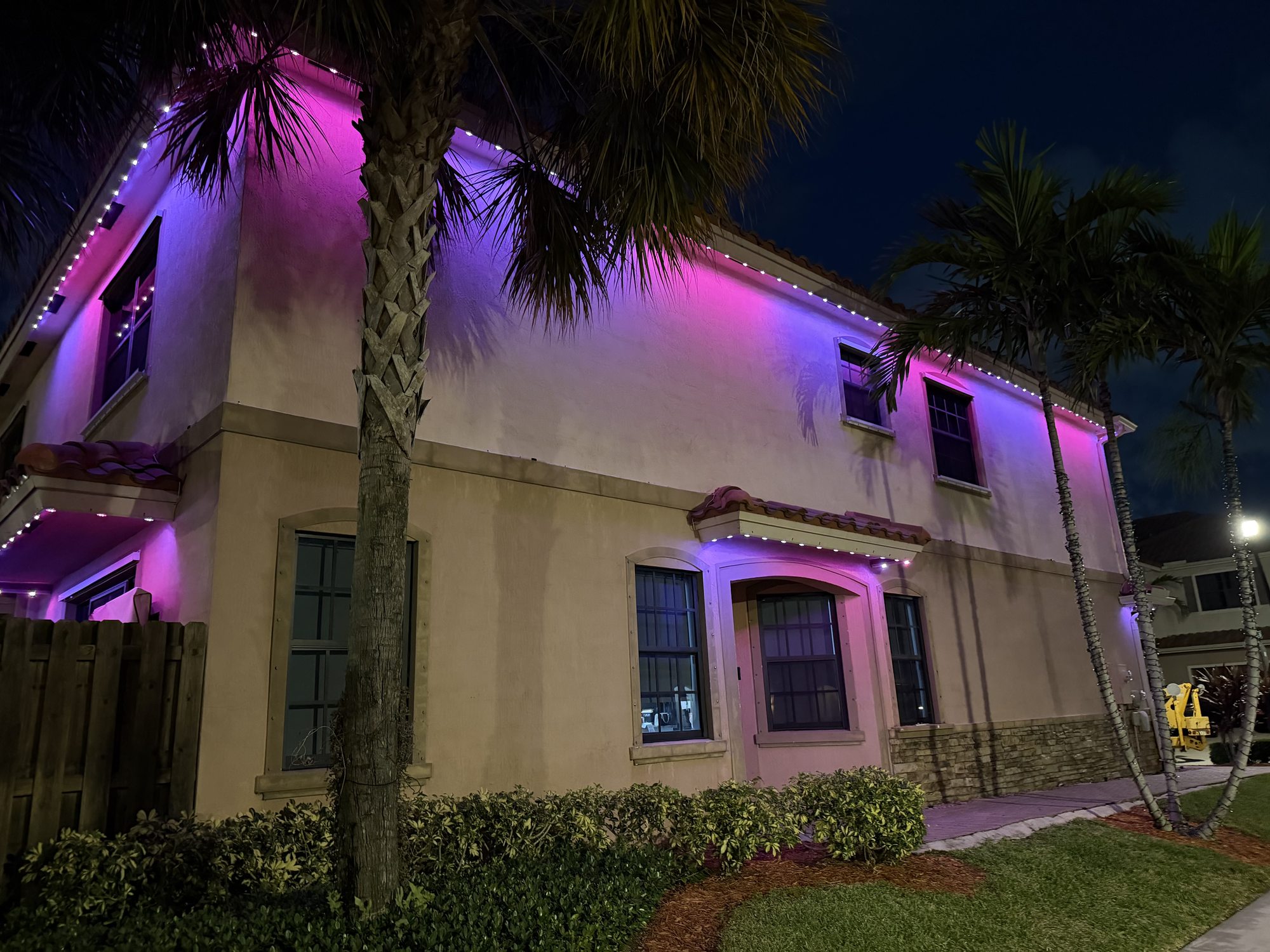 Badger Outdoor Lighting truck at a home with purple permanent roofline lighting