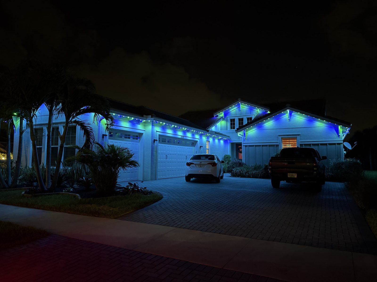 Home with permanent blue roofline lighting