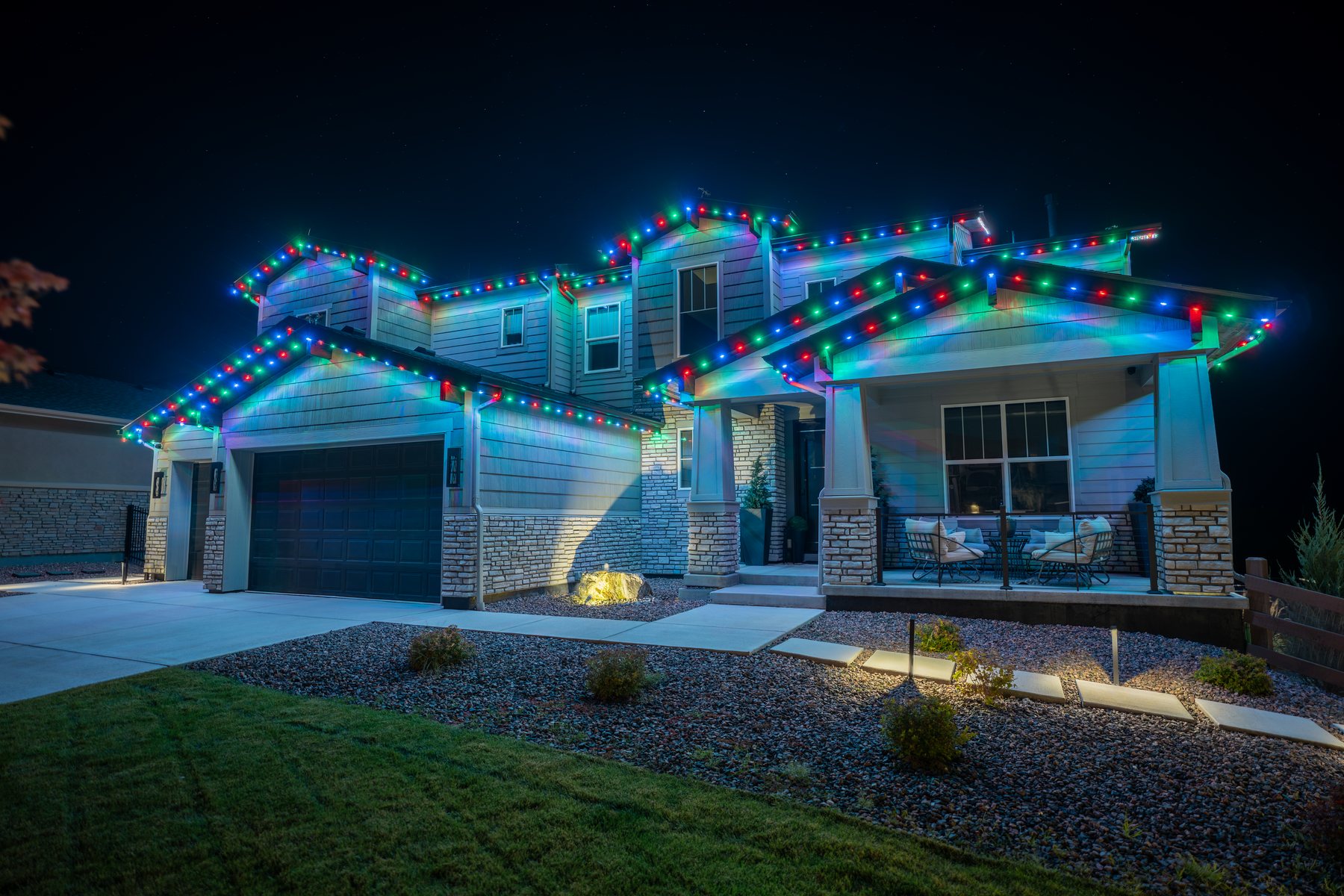 Craftsman home with permanent lighting in full multicolor