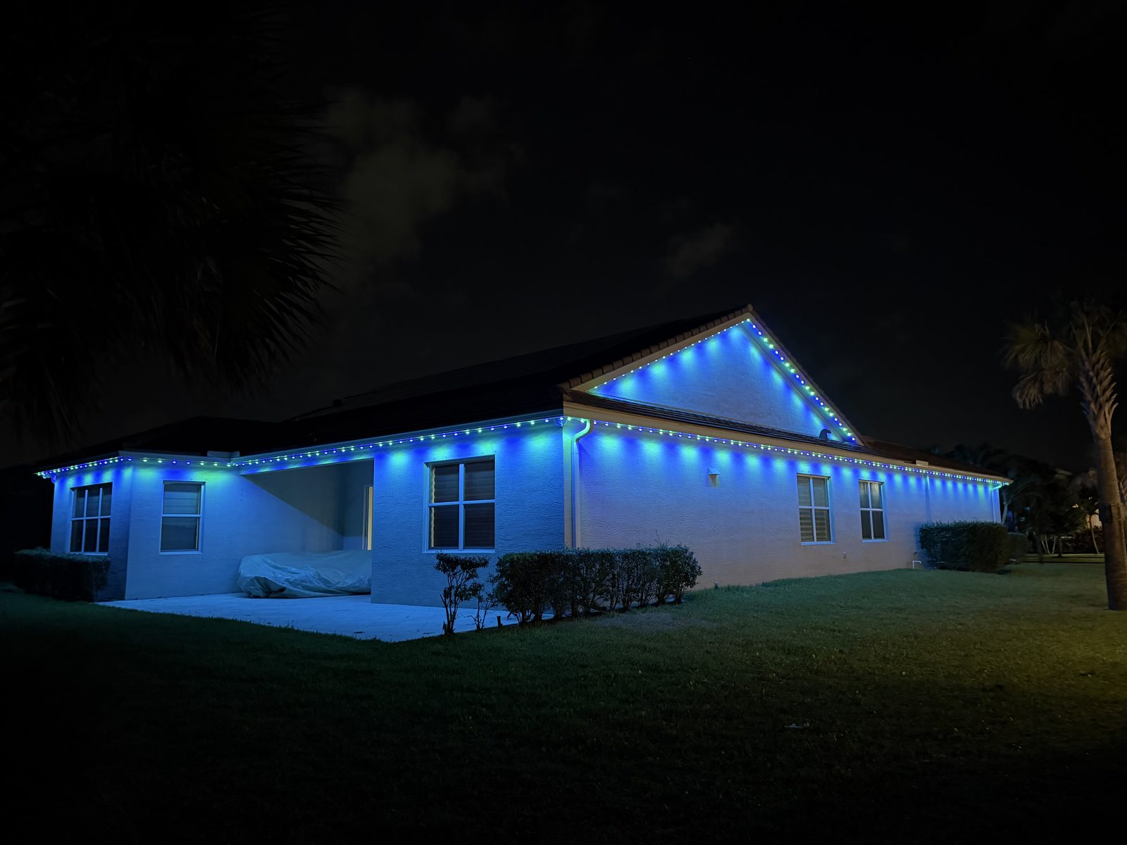 Two-story home with purple and blue permanent lighting