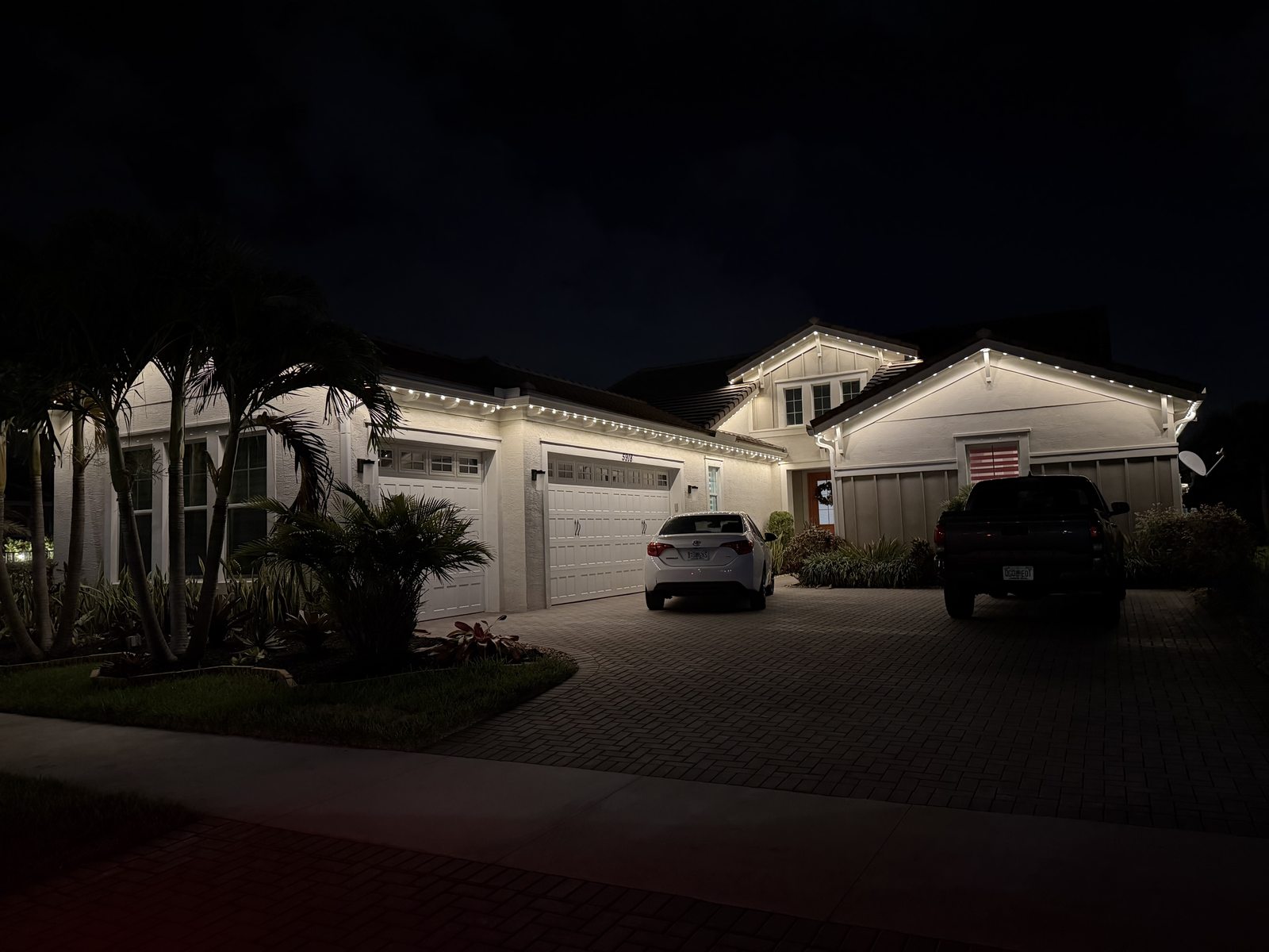 Home with permanent purple roofline lighting