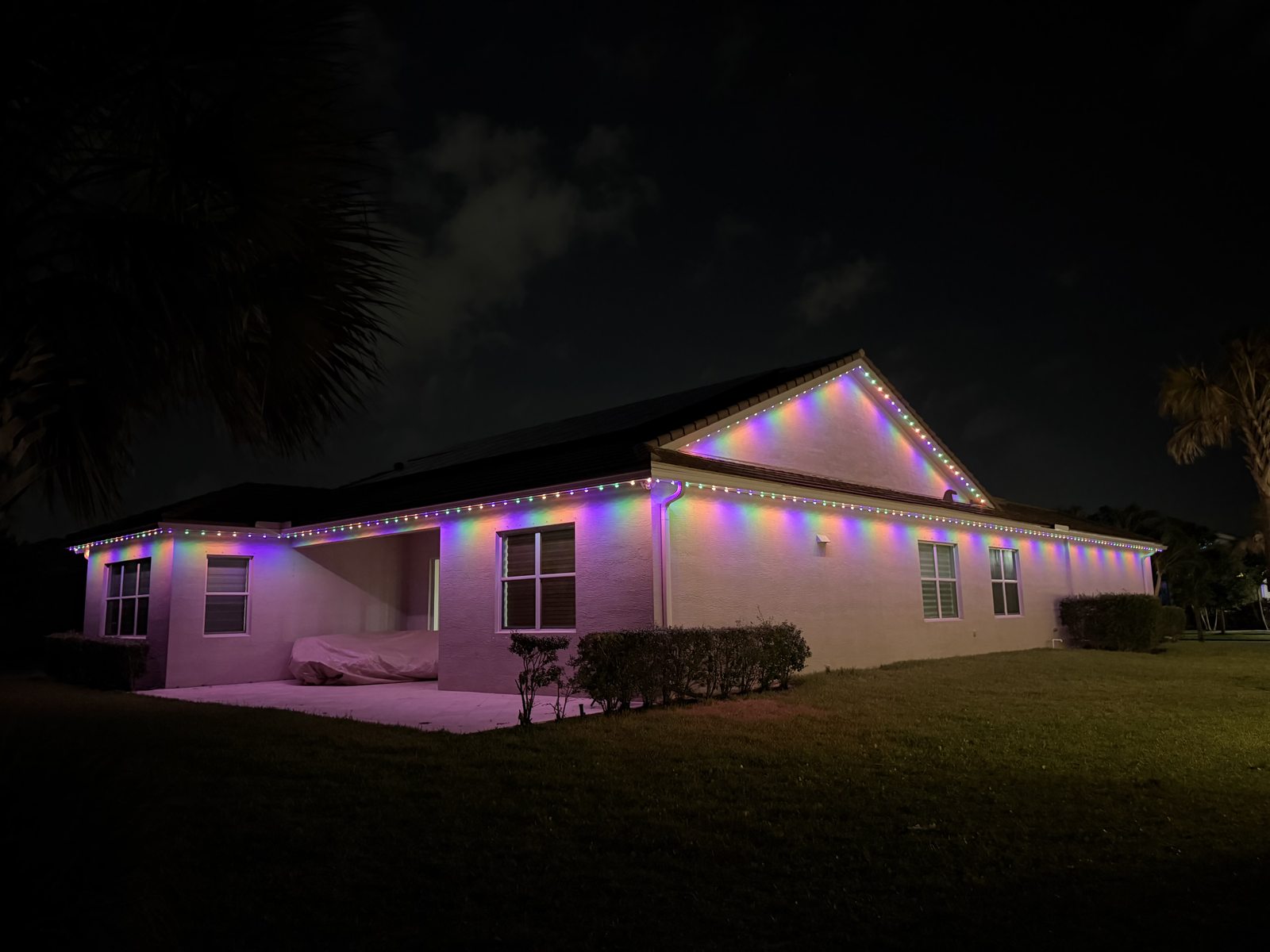 Two-story home with purple permanent lighting