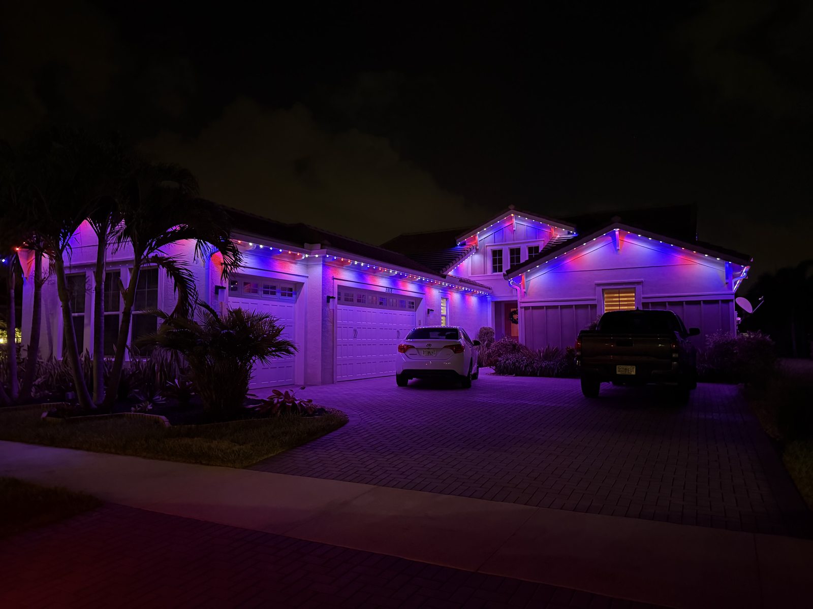 Home with warm white permanent roofline lighting