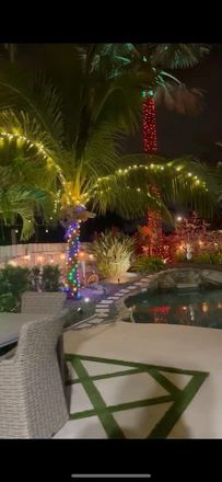Modern home with blue roofline holiday lighting
