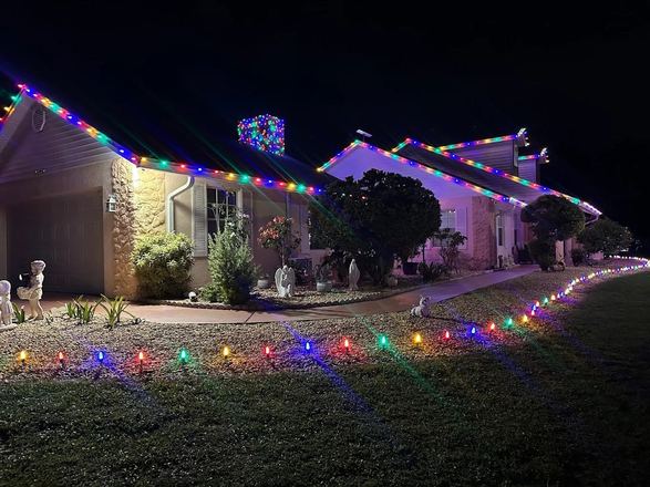 Home with multicolor roofline holiday lights